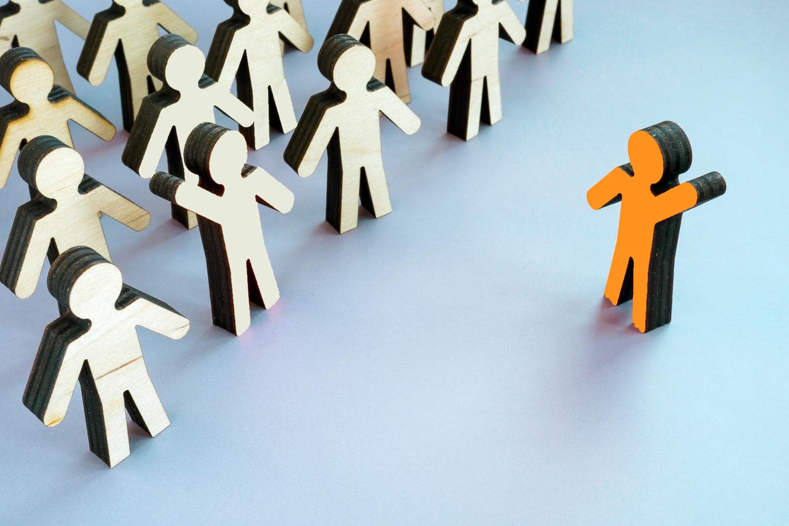 An array of generic human figures in neutral colors on the left, with a distinct orange human figure on the right, symbolizing the standout candidate typically not found on job boards.